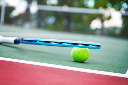 tennis ball and racket on the court, closeup of photoの写真素材