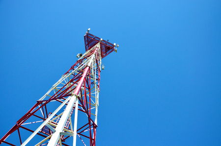 Mobile phone cellular telecommunication radio antenna tower. Cell phone tower against blue skyの写真素材