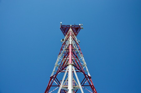 Mobile phone cellular telecommunication radio antenna tower. Cell phone tower against blue sky 1