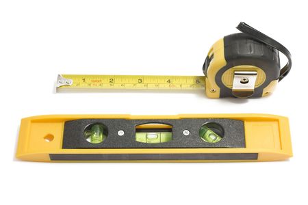 Bubble level and measure tape on white background