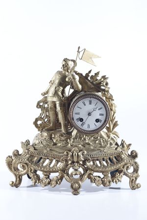 Old mechanical fireplace clock with the knight on white backgroundの写真素材