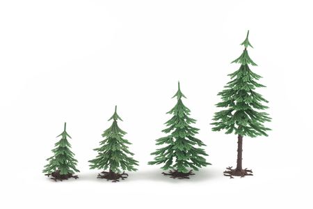 Four plastic fur-trees on white backgroundの写真素材