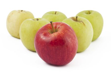 Red apple ahead of the many green apples on white backgroundの写真素材