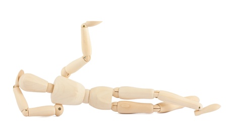 The wooden dummy lies, having raised one hand upwardsの写真素材