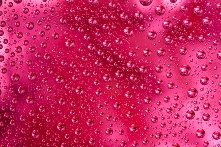 Abstract macro of water drops over red backgroundの写真素材