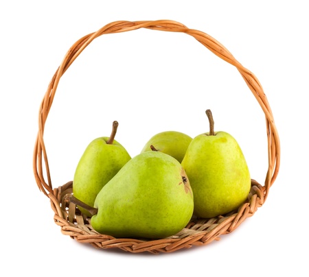 Green ripe pears in wicker basket isolated on white backgroundの写真素材