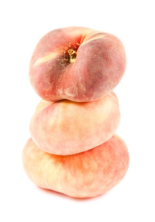Three chinese flat peaches isolated on white background の写真素材