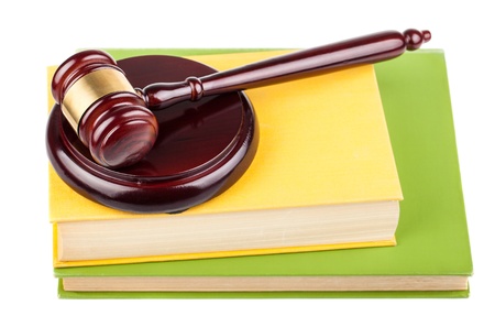 Brown wooden gavel and books isolated on white backgroundの写真素材