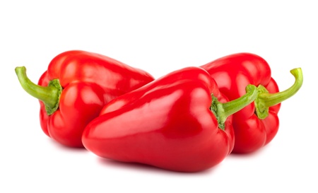 Three ripe red sweet peppers isolated on a white backgroundの写真素材