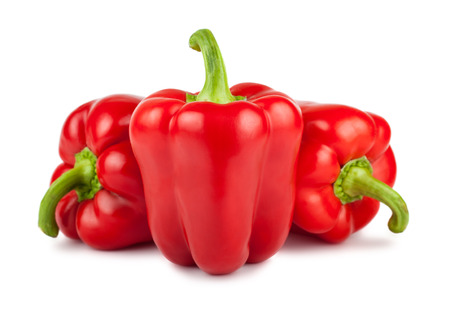 Three red ripe sweet peppers isolated on white backgroundの写真素材