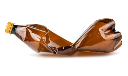 Crumpled brown plastic bottle isolated on white backgroundの写真素材