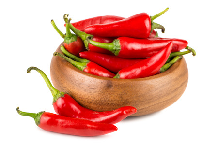 Red hot chili peppers in wooden bowl on white backgroundの写真素材