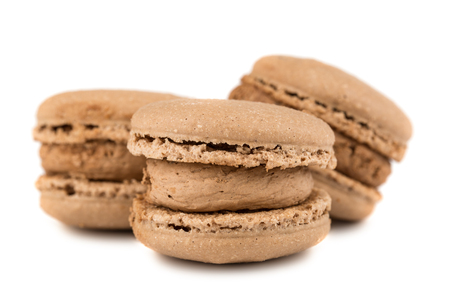 Three brown french macaroon cookies isolated on white backgroundの写真素材