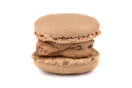 Single brown macaron cookie isolated on white backgroundの写真素材
