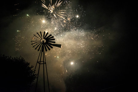Fireworks behind a windmillの写真素材
