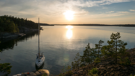 Sundet over a saiboat mored in a natural harbour in the archipelago of Stockholm, Swedenの写真素材