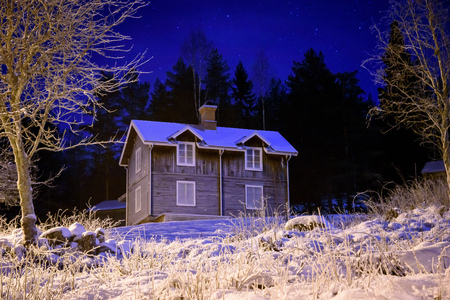 Fosty old cottage during cold winter nightの写真素材