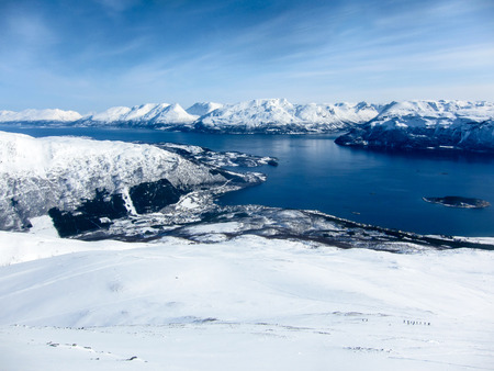 Panorama of winter mountains and fjords from a peak in the Lyngen Alps, Lyngseidet, Norwayの写真素材