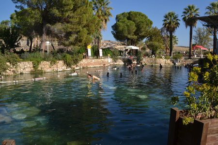 The thermal waters of Cleopatraâs Antique Pool, Pamukkale, Turkey invite visitors to swim among remains of ancient Roman marble columns that fell into pool during an  earthquake.の写真素材