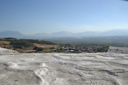 White travertine natural thermal pools of Pamukkale, Turkey, used as a spa in the second century, are famous for their healing properties rich in minerals like sulfur and silica.の写真素材