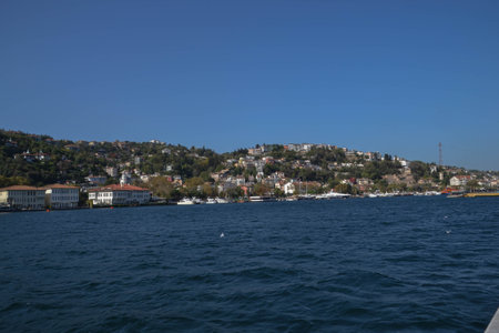 The blue waters of the Bosphorus, Turkey, sparkle along the shores of the European side of Turkey, dotted with villages, homes and resorts.の写真素材