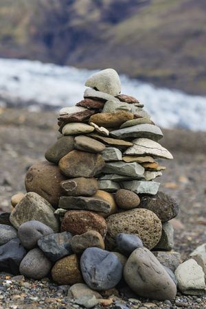 Troll rock pyramid made of stones on a glacier in icelandの写真素材