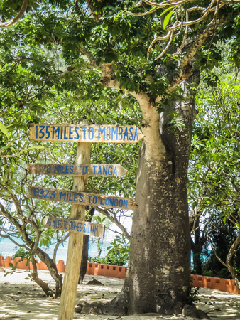 Zanzibar tanzania wooden sign with distances in kilomeaters to different major citiesの写真素材