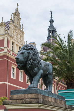 lion statue in front of red castle of Fuerst Pueckler in Bad Muskau Germanyのeditorial素材