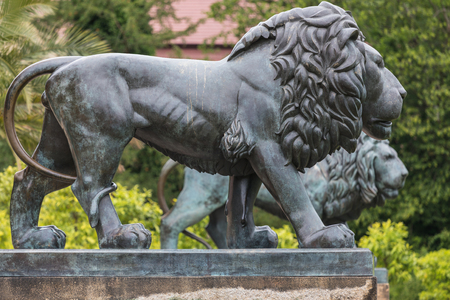 lion statue in front of red castle of Fuerst Pueckler in Bad Muskau Germanyのeditorial素材