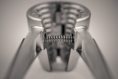 monocrome macro shot of a metal garlic press, kitchenの写真素材