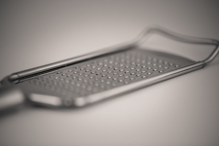 monocrome macro shot of a metal cheese grater, kitchenの写真素材