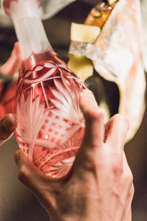 closeup of man grinding or cutting a colorful glass vase, germanyの写真素材