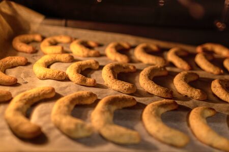baking handmade christmas cookies in the oven, kitchenの写真素材