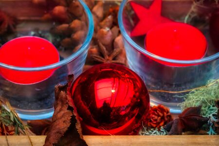 Colorful christmas decoration with pine cones and candles, festiveの写真素材