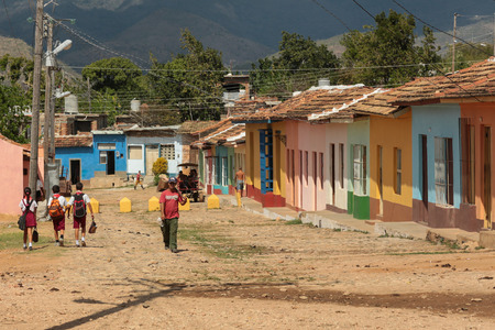 Trinidad, Cuba - February 7, 2014 - School kids an man walking a street in the town of Trinidad, Cuba.のeditorial素材