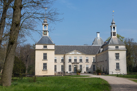Warmond, The  Netherlands - april 24, 2015 - Huys te Warmont is an historic building surrounded by a moat with two towers and a clock. build in the 12th century and rebuild in the 18th centuryのeditorial素材