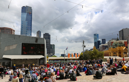 MELBOURNE, AUSTRALIA - November 01, 2016: Melbourne Cup Day at the Federation square, spectators watch the horse race at a big displayのeditorial素材