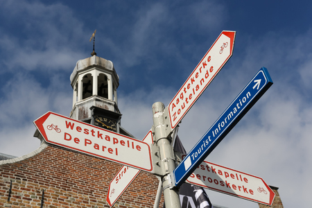 DOMBURG , THE NETHERLANDS - MARCH 24, 2018 - Tourist information sign for cyclist, indicating directions to Westkapelle, Zoutelande, the beach in Zeeland, The Netherlandのeditorial素材