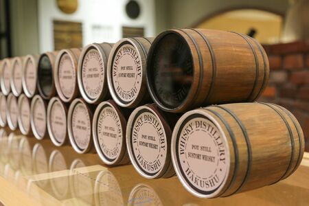 HOKUTO, JAPAN - MAY 25, 2019: Hakushu whisky distillery - miniature barrels on display in the...