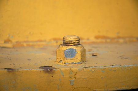 close-up detail od old yellow nut and boltの写真素材