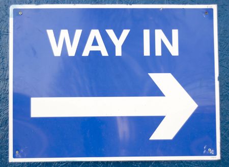 A blue way in sign on a blue wallの写真素材