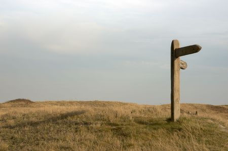 a wooden sign post on footpath in the countrysideの写真素材