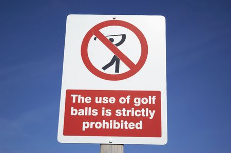 A sign to ban golf balls on a blue skyの写真素材