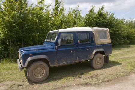 A four wheel drive truck on a farm track
