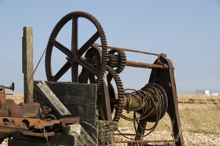 An old fishermans winch on the beachの写真素材