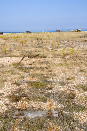 The beach at Dungeness with some huts in the distanceの写真素材