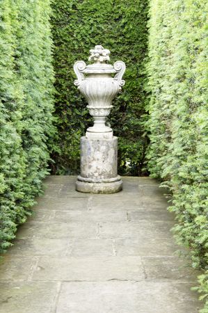 A stone statue in a garden settingの写真素材