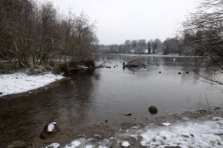 A view of a lake in winter with snowの写真素材