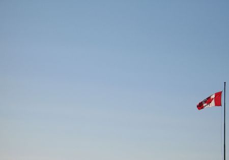 canadian flag in the blue skyの写真素材