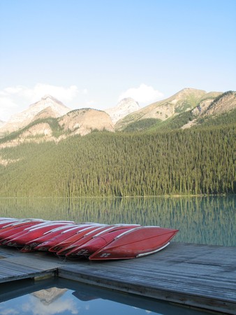 canoes by a lake and mountainsの写真素材